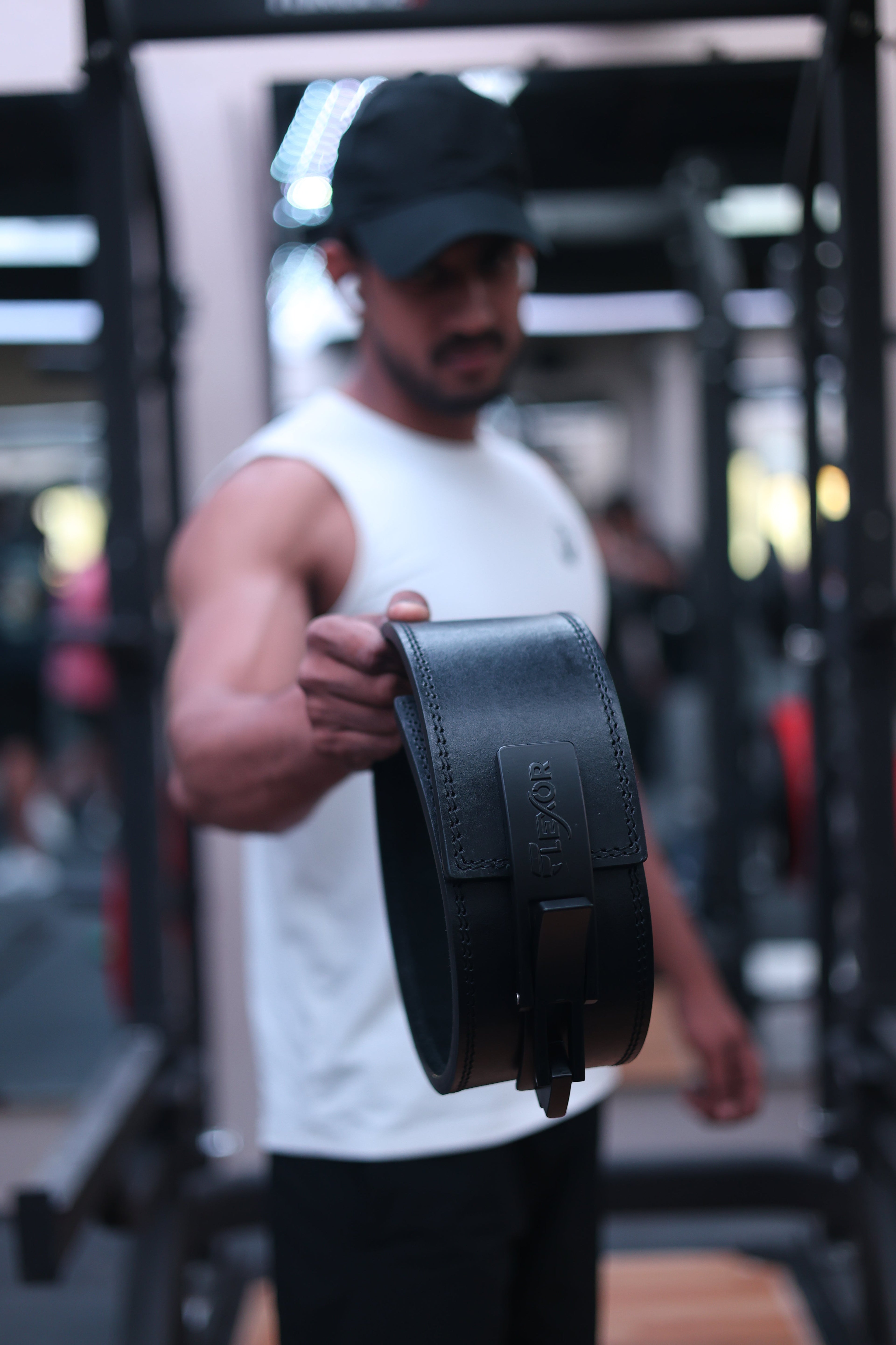 Athlete holding a premium lever belt, highlighting 10 mm powerlifting lever belts in India and quality gym belts India.